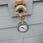 Home Water pressure gauge measuring high water pressure that may require a pressure control valve