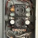Home Old fuse box still in use as main electrical panel in Spokane, WA, outdated and unsafe for modern electrical demands