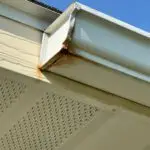 Home Rusted and leaking gutter end in Spokane, WA showing failure from deferred maintenance